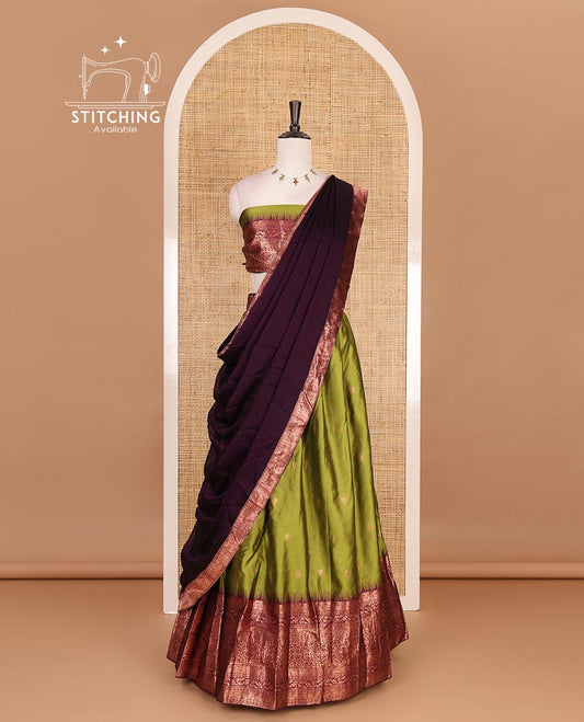 Leaf green taffeta silk half saree, zari buttas with contrast purple traditional zari border, matching zari blouse, and contrast plain zari border dhavani