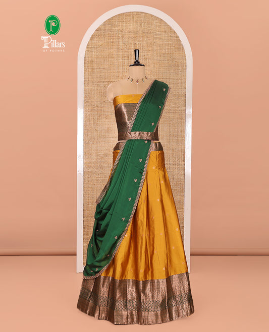 Yellow and Green Semi-Banarasi Half-Saree Decked Up with Zari Buttas on Its Skirt, Complemented by a Contrast Traditional Zari Border of Jaal Design, Paired with a Matching Blouse, and a Satin Georgette Embroidered Scallop Dhavani