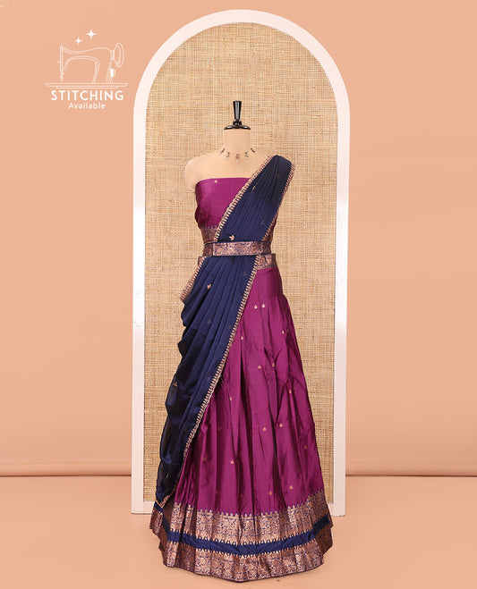 Dark Magenta and Blue Semi-Banarasi Half-Saree, Accentuated with Zari Buttas on Its Skirt, Complemented by a Contrast Rettai Pettu Traditional Zari-Design Border, Paired with a Matching Blouse, and Comes with a Contrast Satin Georgette Embroidered Dhavani