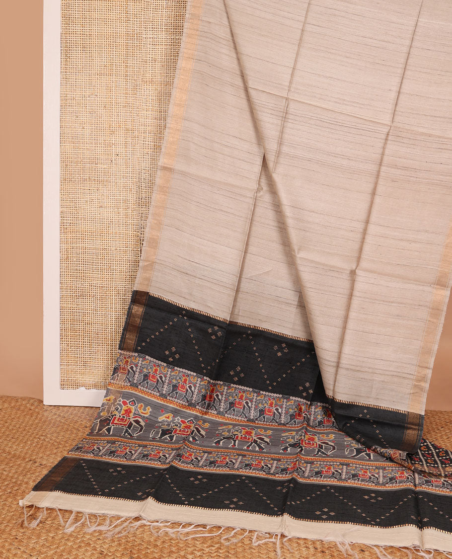 Sandal plain design tussar saree, zari border & contrast pallu adorned with patola-style elephant motifs print