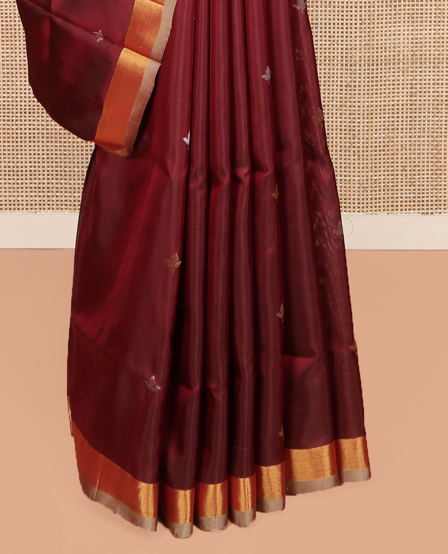 Maroon Uppada Silk Saree, Adorned with Zari Buttas All Over Its Body, Complemented by a Contrast Plain Border, Pallu Features Floral Jaal Designs, and Paired with a Matching Blouse