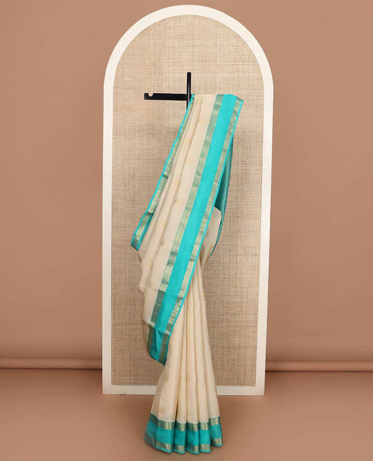 Cream zari checked and buttas Vasundhara silk mix saree, contrast rettai pettu border of thilakam, banaras, and kodi visiry designs, and pallu of peacock motifs