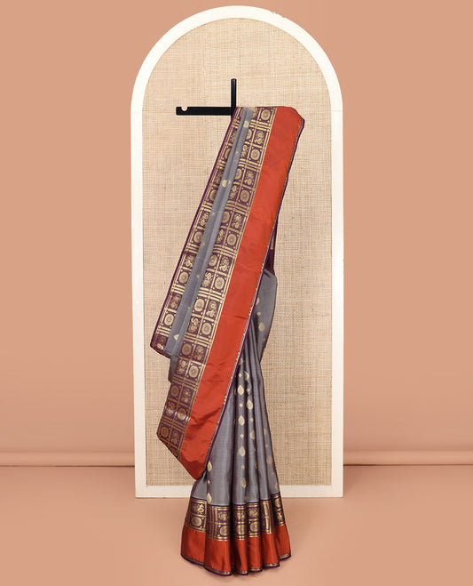 Grey Vasundhara Lite Silk Mix Saree, Opulently Embellished with Zari Buttas, Complemented by Contrast Kal Eragina Border of Annam Chakram Designs, Scintillating 3d Textured-Like Zari Woven Pallu, and Paired with a Contrast Blouse