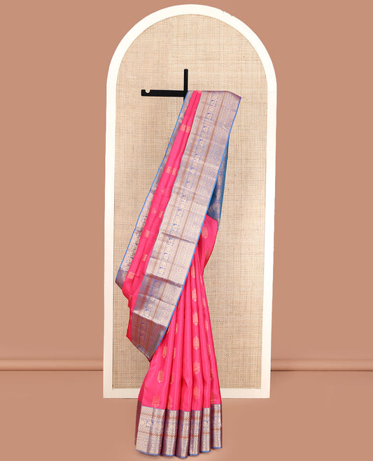 Pink Vasundhara Lite Silk Mix Saree, Beautified with Deepam Buttas, Complemented by a Contrast Border of Thilakam Mokku, Poun, Muthu, Diamond and Chakram Designs, Pallu Steeped with Chakram Designs, and Paired with a Contrast Blouse