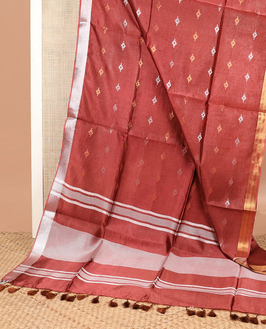 Terracotta red diamond buttas banana pith saree, silver and gold bavanji border, and zari striped pallu