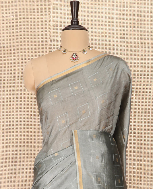 Grey Banana Pith Saree Woven with Zari Buttas Enclosed Squares, Subtly Woven Piping Border, Pallu of Stripes, and Paired with a Matching Plain Blouse