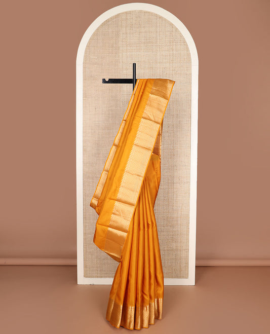 Mango yellow plain silk saree, zari border of thazampoo rekku & geometric patterns & vanki pallu