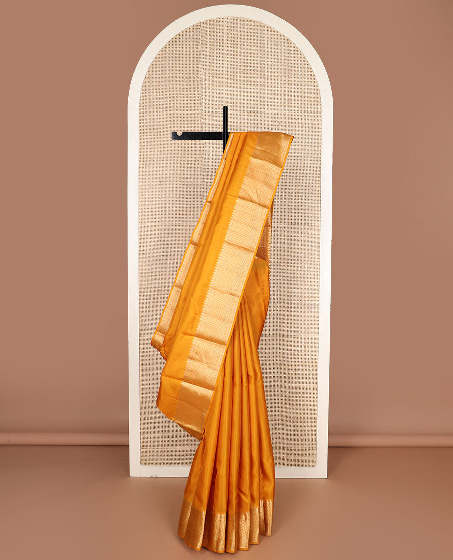 Mango yellow plain silk saree, zari border of thazampoo rekku & geometric patterns & vanki pallu