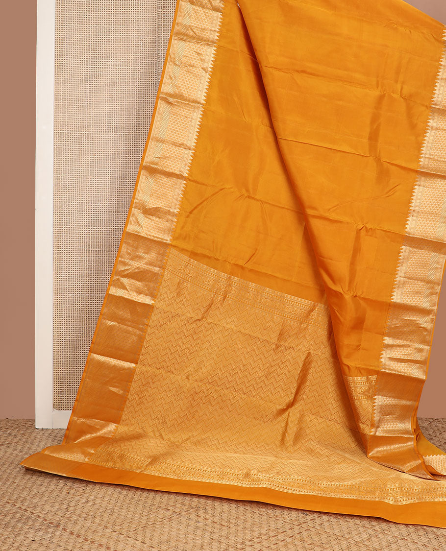 Mango yellow plain silk saree, zari border of thazampoo rekku & geometric patterns & vanki pallu