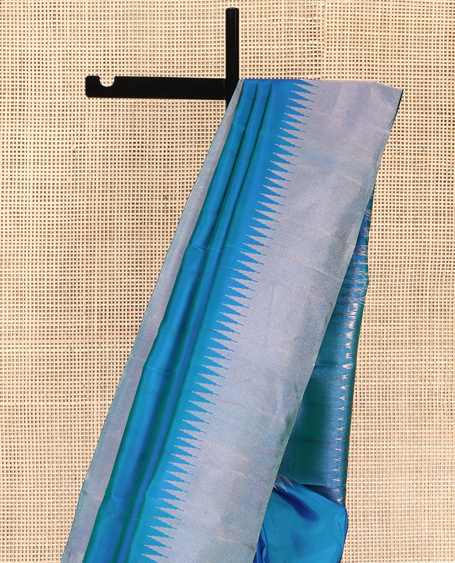 Blue Plain Vasundhara Silk Saree, Highlighted by Thazampoo Rekku Zari Border, Pallu of Mayil Kann, and Yaali Designs, and Paired with a Matching Blouse