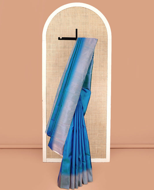Blue Plain Vasundhara Silk Saree, Highlighted by Thazampoo Rekku Zari Border, Pallu of Mayil Kann, and Yaali Designs, and Paired with a Matching Blouse