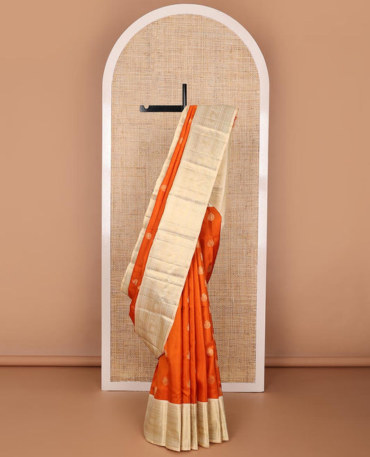 Orange zari buttas silk saree, contrast mayil kann pallu & border of thilakam,kathir,rudraksham,mayil kann & annam chakram
