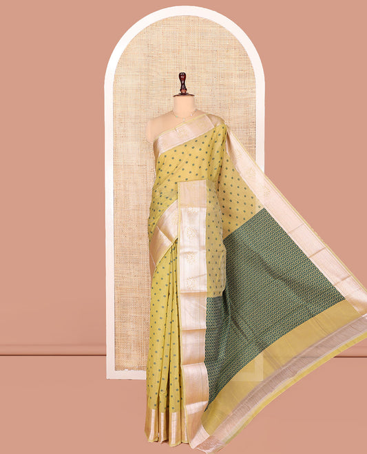 Green Semi-Silk Cotton Saree, Sparsely Woven with Floral Buttas on Its Body, Highlighted by a Zari Traditional Border, Geometric Patterned Pallu, and Paired with a Matching Blouse