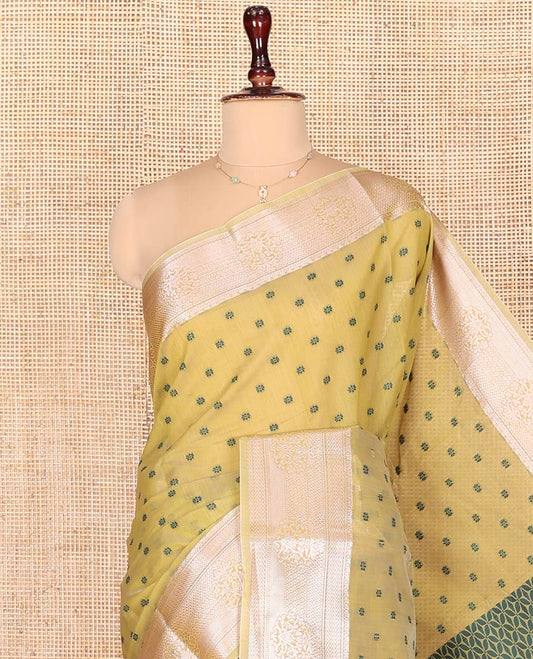 Green Semi-Silk Cotton Saree, Sparsely Woven with Floral Buttas on Its Body, Highlighted by a Zari Traditional Border, Geometric Patterned Pallu, and Paired with a Matching Blouse