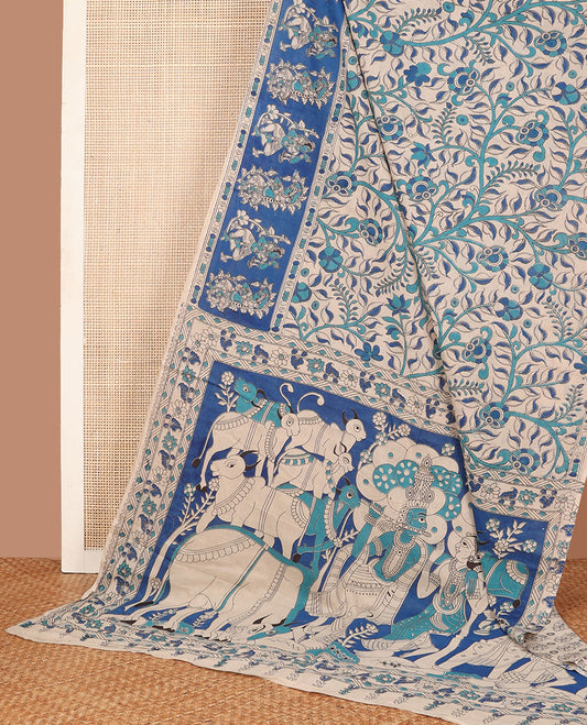 Sandal-base blue floral vine machine-printed kalamkari cotton saree, contrast human motifs printed border & pallu of Pichwai cow & Radha Krishna print