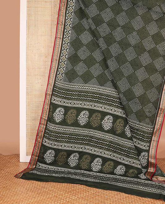 Green batik style argyle printed mul mul cotton saree, contrast traditional motifs border, and pallu of geometric and paisley print