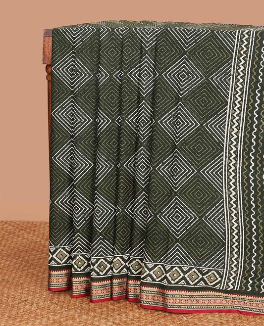 Green batik style argyle printed mul mul cotton saree, contrast traditional motifs border, and pallu of geometric and paisley print