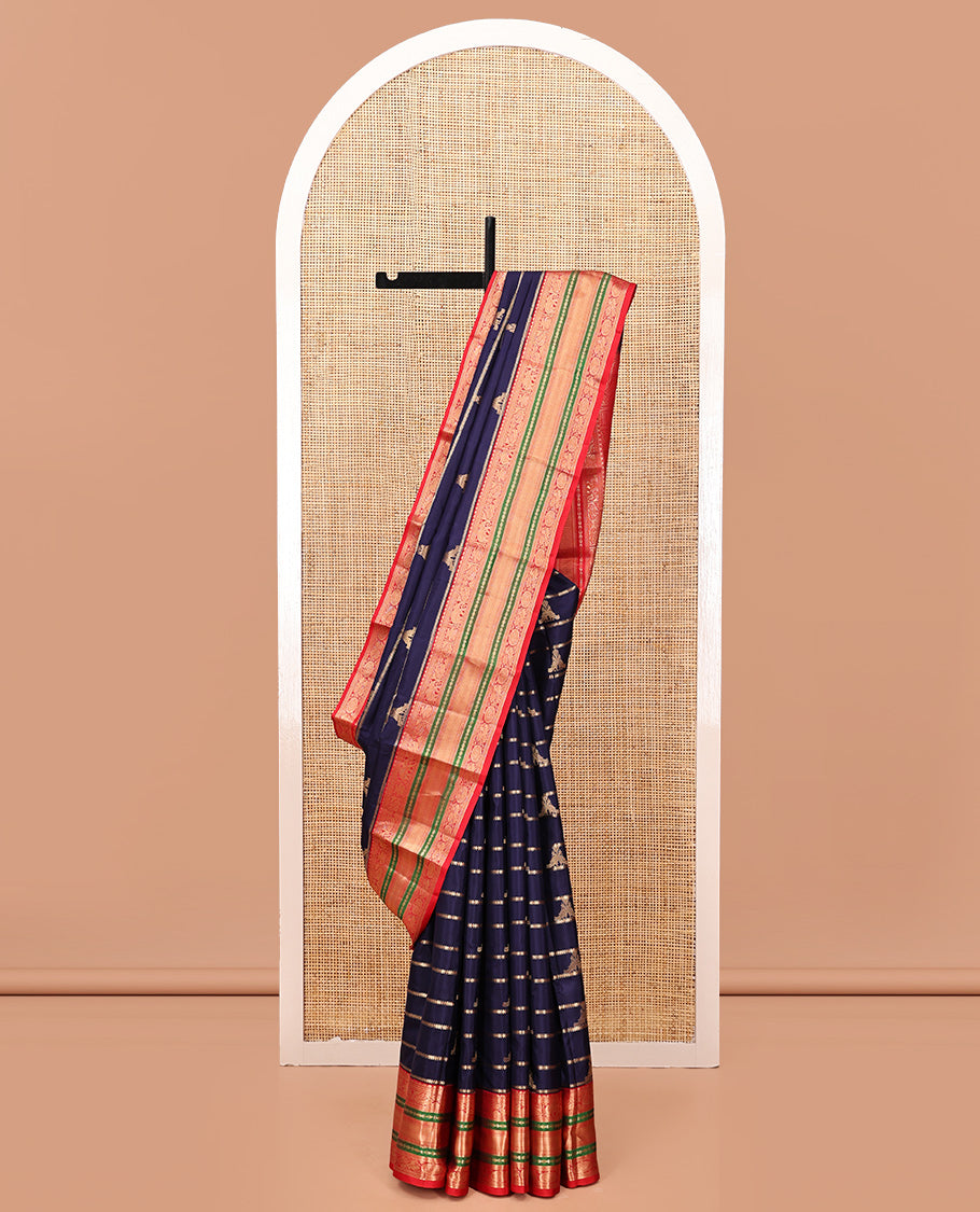 Blue Vasundhara Silk Saree, Accentuated with Zari Buttas and Stripes All Over Its Body, Complemented by a Contrast Border of Elephant, Mayil, and Chakram Designs, a Grand Pallu, and Paired with a Contrast Blouse