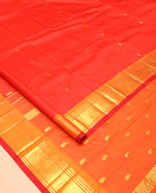 Orange Kanchipuram Silk Saree, Bedecked with Zari Buttas All Over Its Body, Complemented by a Contrast One-Sided Border of Panner Sombu, Banaras, and Mayil Kann Designs, Pallu of Zari Designs, and Comes Without a Blouse
