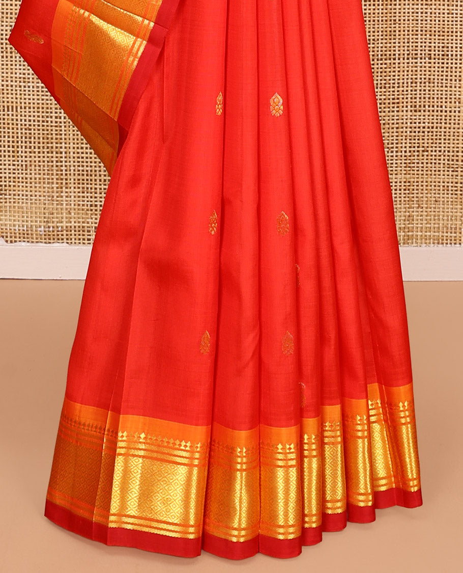 Orange Kanchipuram Silk Saree, Bedecked with Zari Buttas All Over Its Body, Complemented by a Contrast One-Sided Border of Panner Sombu, Banaras, and Mayil Kann Designs, Pallu of Zari Designs, and Comes Without a Blouse