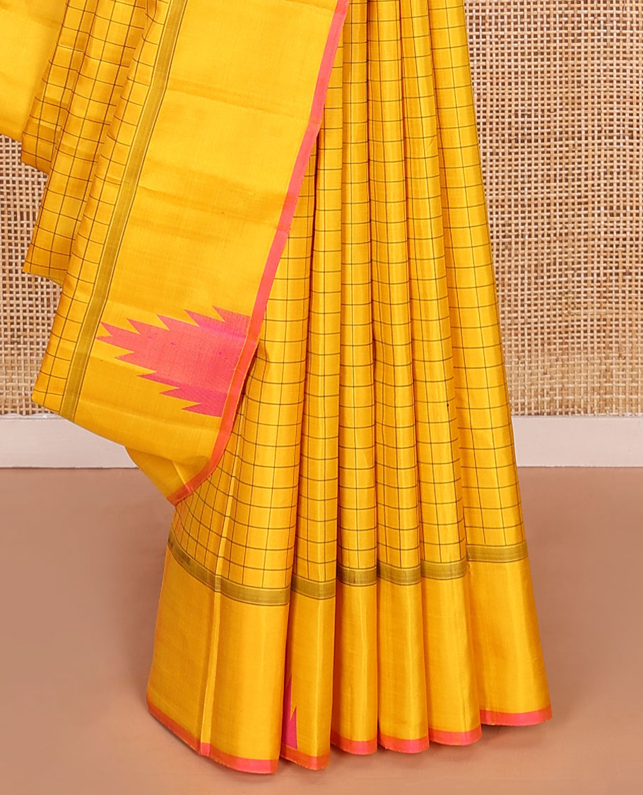 Yellow checked Kanchipuram silk saree, thazampoo rekku border, and pallu of pillaiyar mokku, and seppu rekku designs