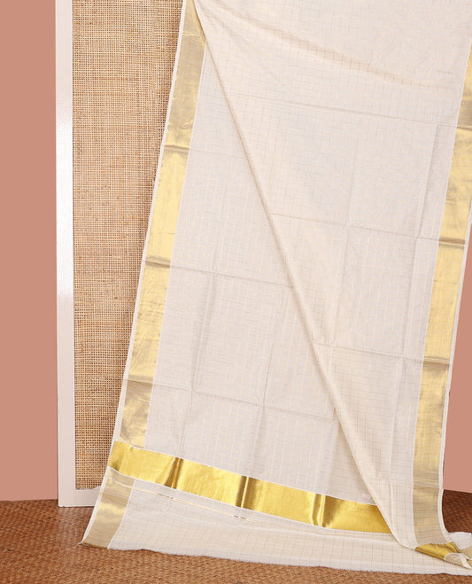 Cream Kerala Saree, Subtly Sparkled with Checks on Its Body, Gleaming Zari Pallu, and Paired with a Matching Blouse