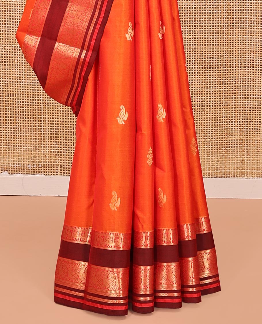 Orange Vasundhara Lite Silk Mix Saree, Accentuated With Zari Buttas All Over Its Body, Complemented by Captivating Contrast Border of Rekku, Mayil, Kuthirai, Yaanai, and Neli Designs, Grand Pallu, and Paired with a Contrast Blouse