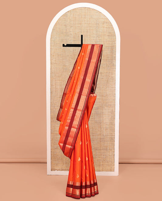 Orange Vasundhara Lite Silk Mix Saree, Accentuated With Zari Buttas All Over Its Body, Complemented by Captivating Contrast Border of Rekku, Mayil, Kuthirai, Yaanai, and Neli Designs, Grand Pallu, and Paired with a Contrast Blouse