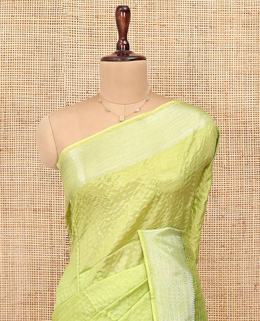 Green Banana Pith Saree, Sparsely Woven with Stripes All Over Its Body, Subtle Self-Border of Jaal Designs, Pallu Steeped with Stripes, and Paired with a Matching Blouse