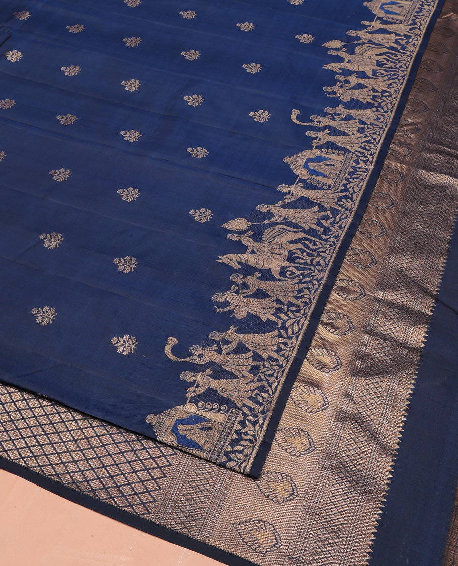 Blue Vasundhara Silk Saree Gleamed Up with Zari Buttas  All Over Its Body, Highlighted by a Zari Border of Wedding-Themed Bridegroom Designs, Pallu Majestically Detailed with Jaal Designs, and Paired with a Matching Blouse