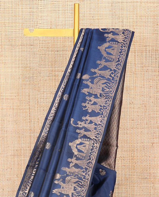 Blue Vasundhara Silk Saree Gleamed Up with Zari Buttas  All Over Its Body, Highlighted by a Zari Border of Wedding-Themed Bridegroom Designs, Pallu Majestically Detailed with Jaal Designs, and Paired with a Matching Blouse