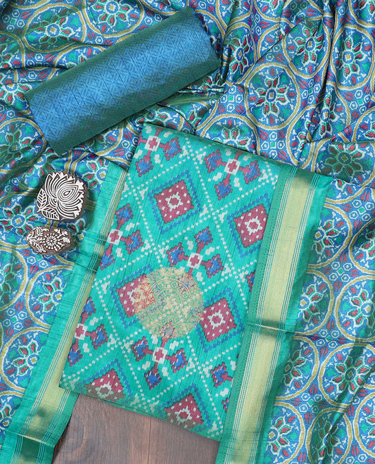 Turquoise material chudidhar,intricate print & butta patola silk top,contrast printed bottom & intricate dupatta