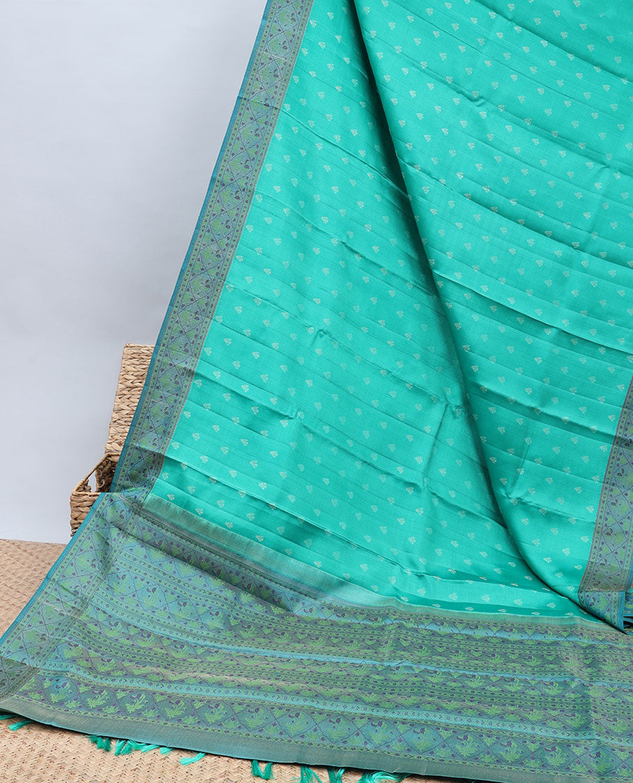 Green kancheepuram silk saree with buttas, contrast border & pallu of floral designs