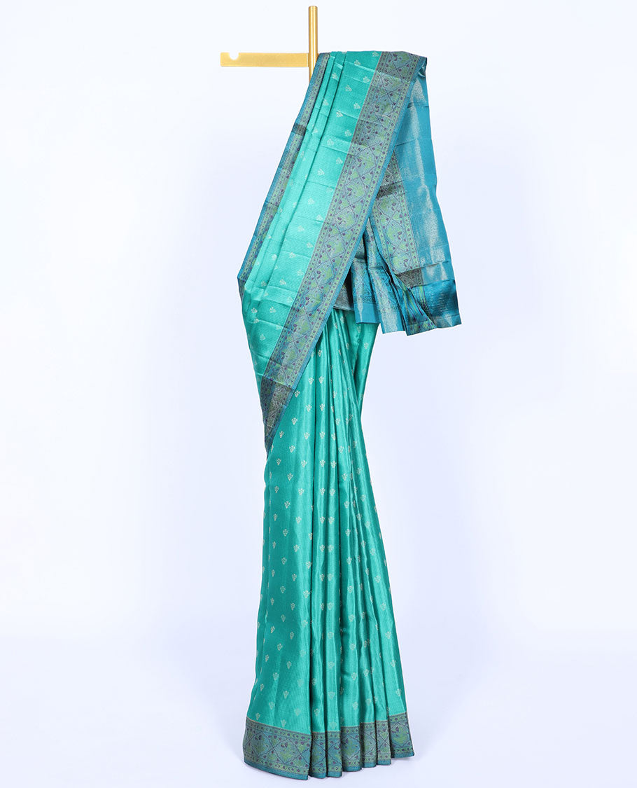 Green kancheepuram silk saree with buttas, contrast border & pallu of floral designs