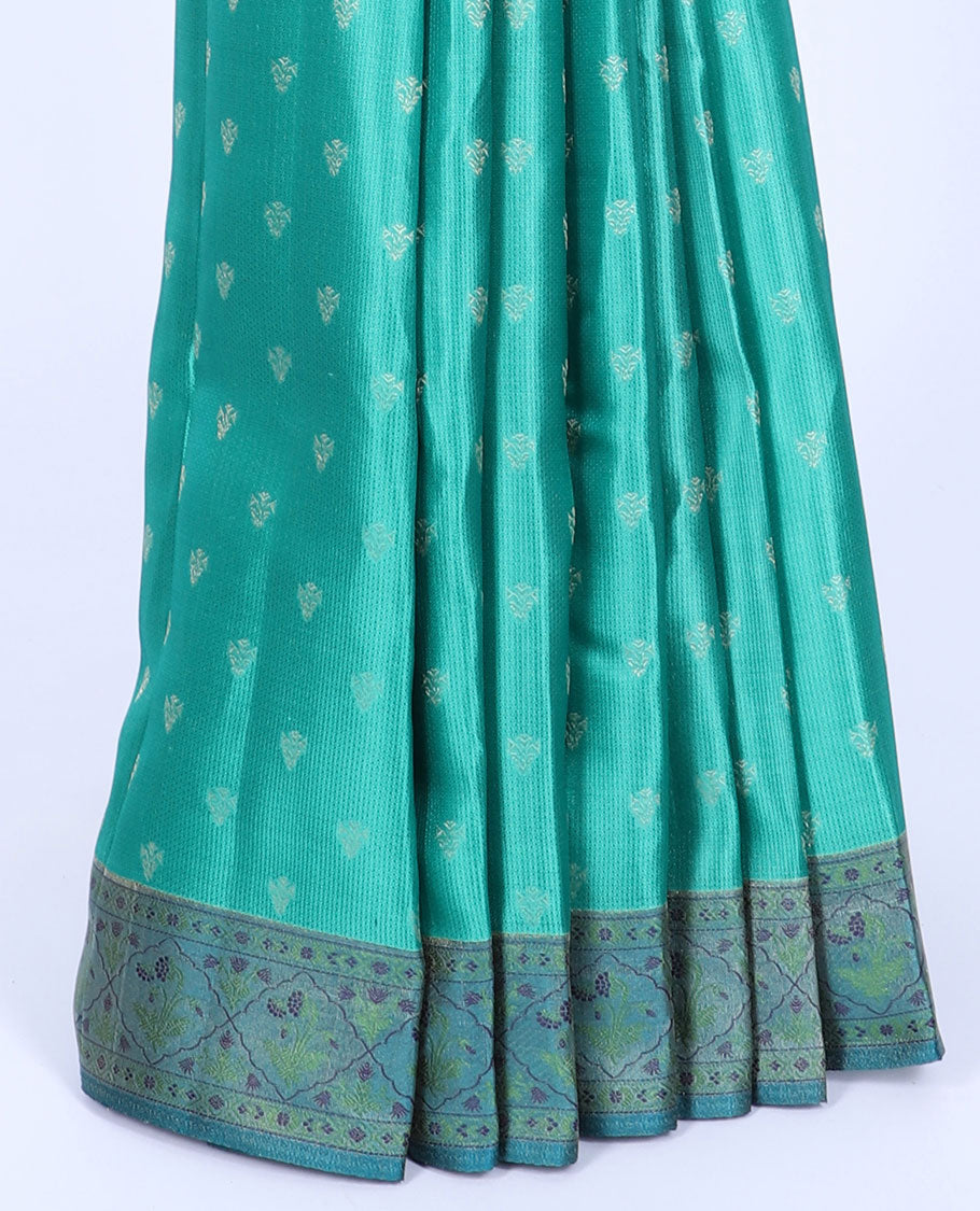 Green kancheepuram silk saree with buttas, contrast border & pallu of floral designs