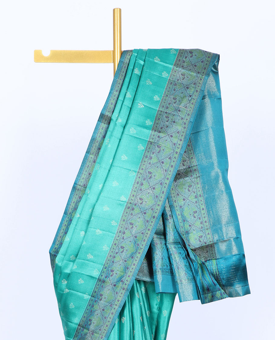 Green kancheepuram silk saree with buttas, contrast border & pallu of floral designs