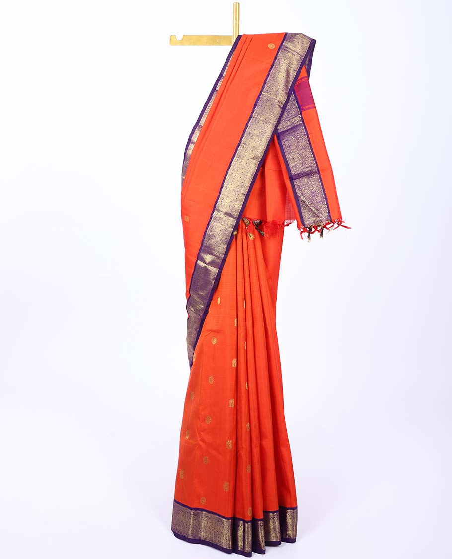 Orange kancheepuram silk saree with mayil & chakram buttas,contrast korvai border of rekku,muthu,lavangam,mayil & yaanai