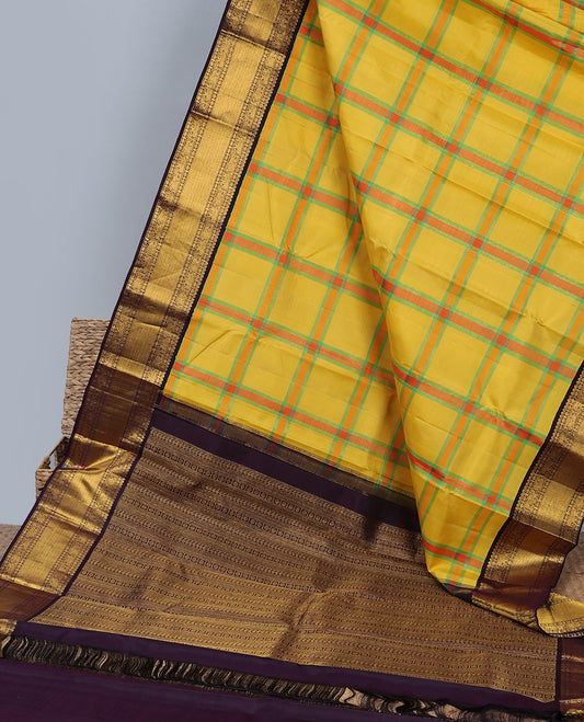 Yellow checked design silk saree, contrast korvai border of thilakam mokku,muthu,poun,mayil & yaanai
