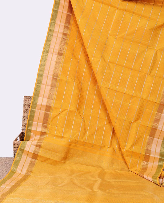 Yellow embossed silk saree with sparkling zari stripes, intricate pallu & zari border of thilakam mokku & manga designs
