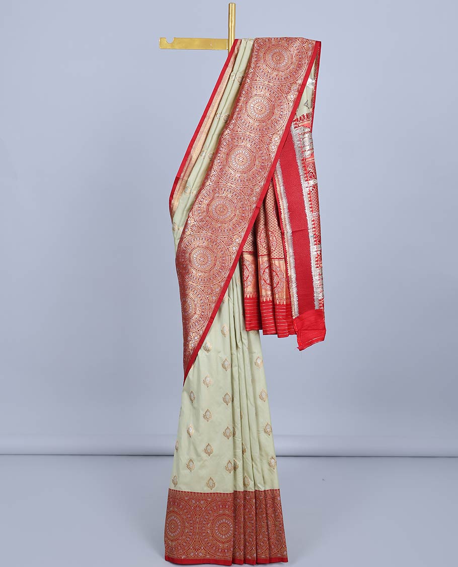 Pale green semi-banaras jute saree with buttas, contrast border of chakram designs & intricate pallu