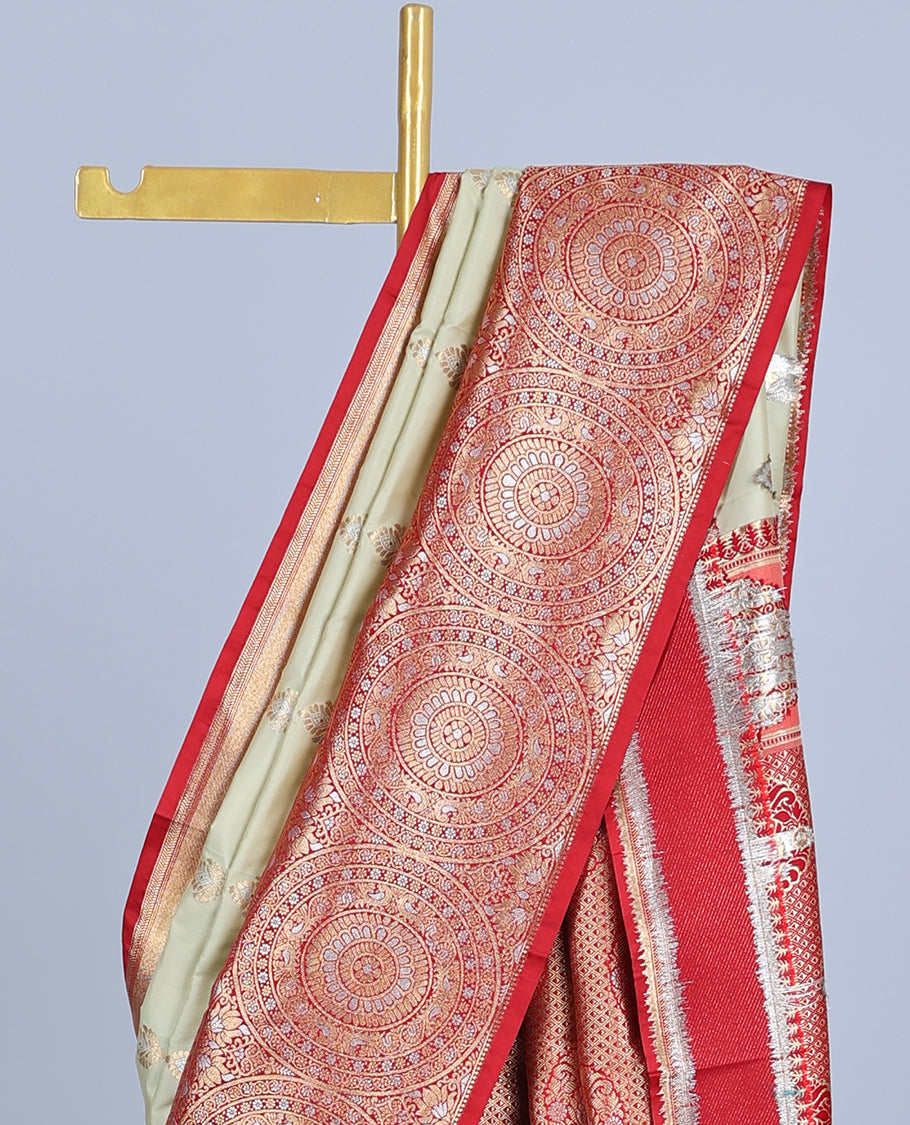 Pale green semi-banaras jute saree with buttas, contrast border of chakram designs & intricate pallu