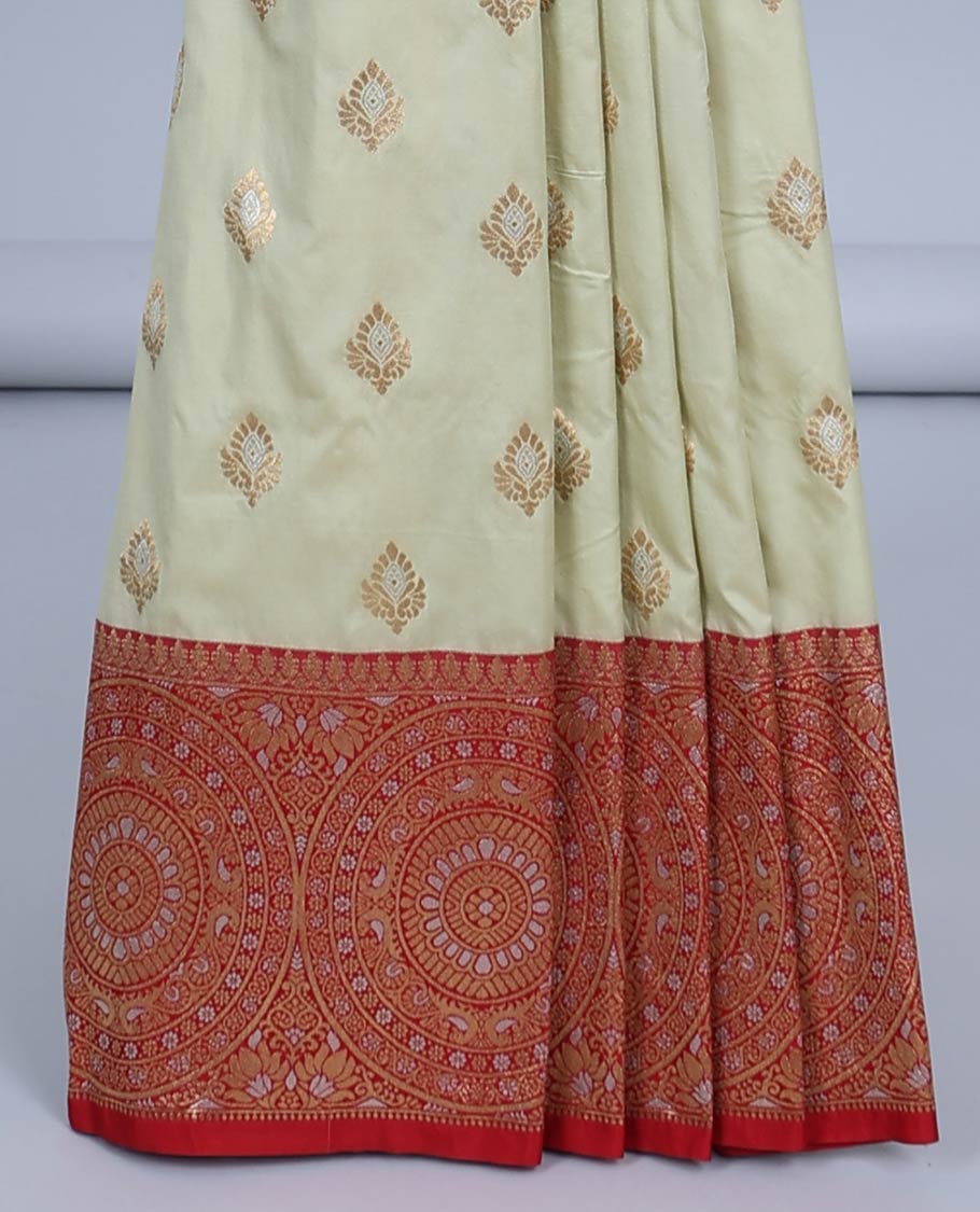 Pale green semi-banaras jute saree with buttas, contrast border of chakram designs & intricate pallu