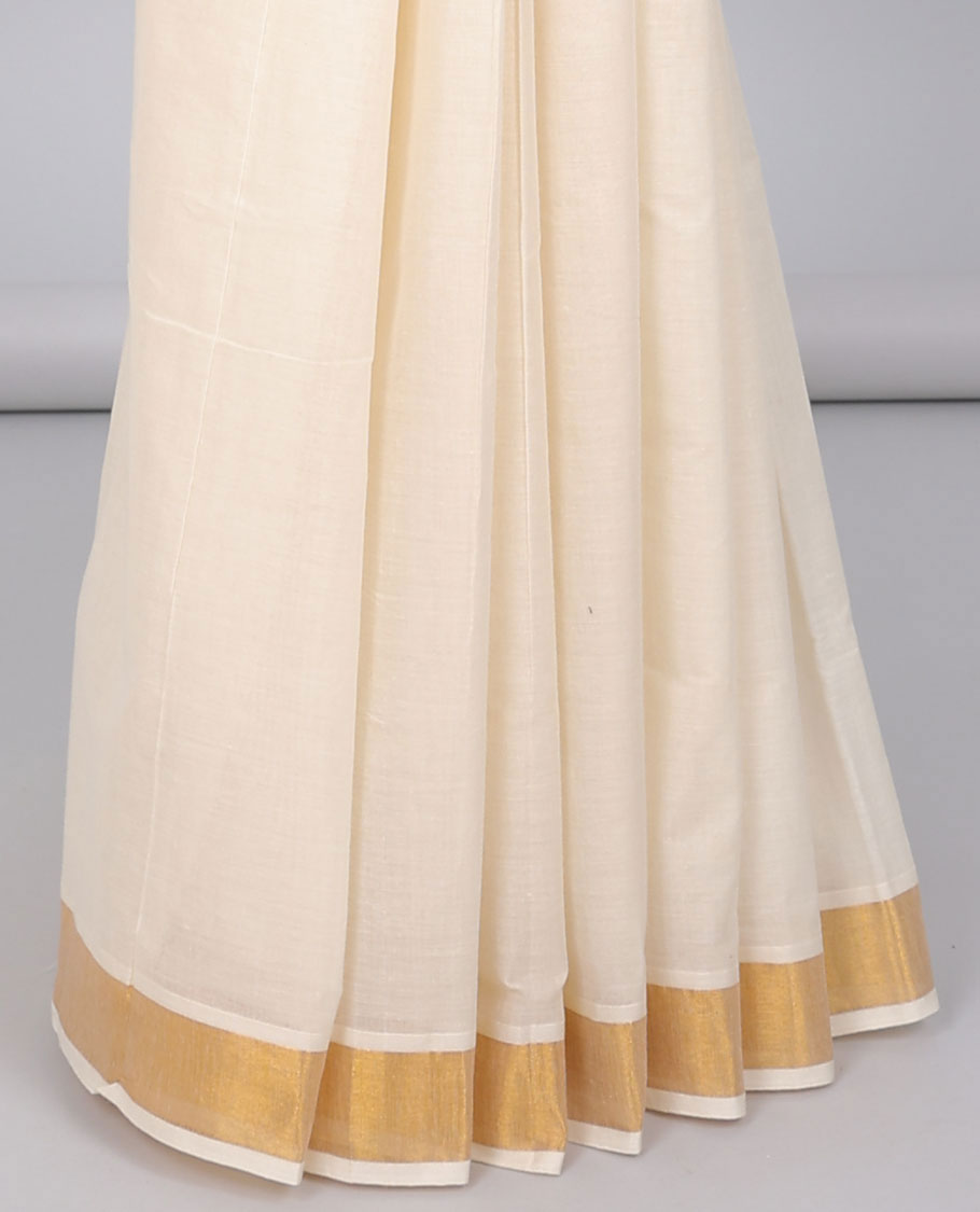 Cream kerala saree with zari designs, zari border & pallu of intricate designs in zari