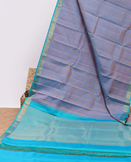 Violet embossed & zari butta silksaree,contrast border of thilakam mokku,muthu & vanki design & pallu of poun