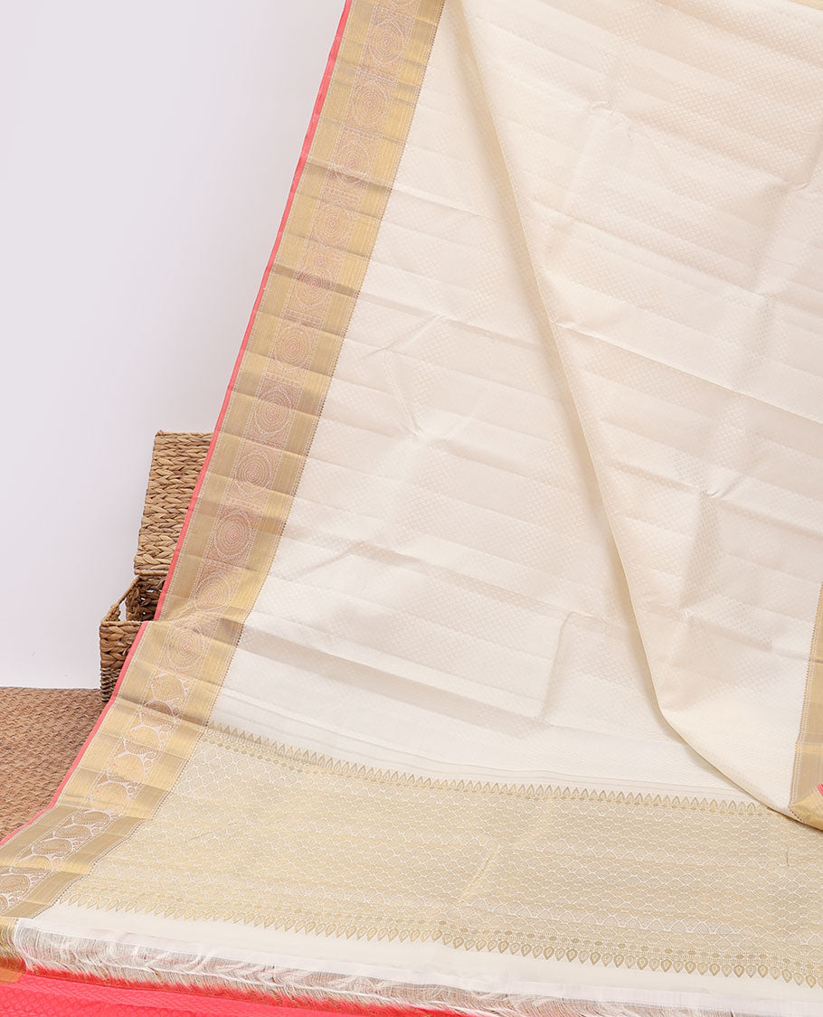 Cream embossed silksaree with buttas, contrast jaal pallu & border of rekku,poun,zari stripes &  chakram