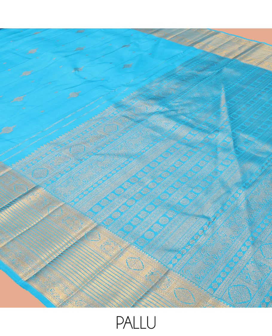 Blue Kanchipuram Silk Saree, Mesmerized with Zari Buttas, Highlighted by Zari Border of Thilakam Mokku, Kathir, Mayil, Chakram, and Yaali, Grand Pallu, and Matching Blouse