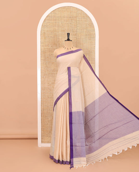 Cream-violet plain mercerised cotton saree,contrast plain  border, striped pallu, and a contrast plain blouse