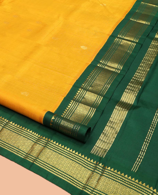 Yellow Kanchipuram Silk Saree, Subtly Sparkled with Zari Buttas on Its Body, Complemented by a Contrast One-Sided Korvai Border of Thazampoo Rekku, Banaras, Muthu, and Jaal Designs, Pallu Features Zari Designs, and Comes Without a Blouse