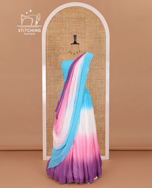Multi-color half-saree, ombre-colored viscose georgette skirt, a plain blue blouse, and a ombre-colored zari striped dhavani