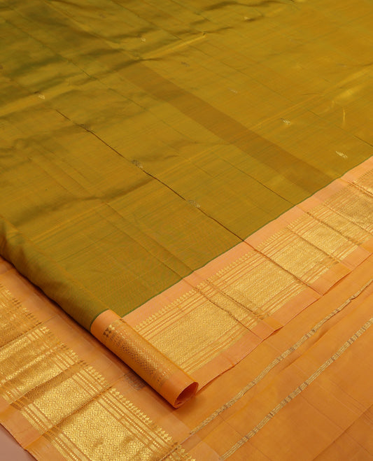 Green Kanchipuram Silk Saree, Accentuated with Zari Buttas, a Contrast One-sided Border of Panner Sombu, Banaras, Muthu, and Jaal Designs, Pallu of Zari Designs, and No Blouse